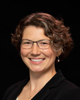 headshot of woman against black backdrop