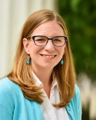 Headshot of woman outside wearing glasses